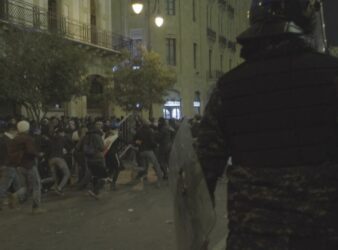 Protesters in Beirut run from Internal Security Forces on Sunday, December 15. (Lujain Jo)