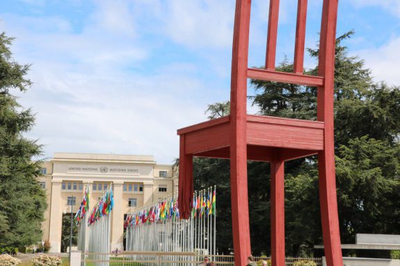 Photo of the Broken Chair, a giant wooden sculpture of a three-legged chair. In the background, the entrance to the UN building can be seen. (The Culture Trip | Sean Mowbray)