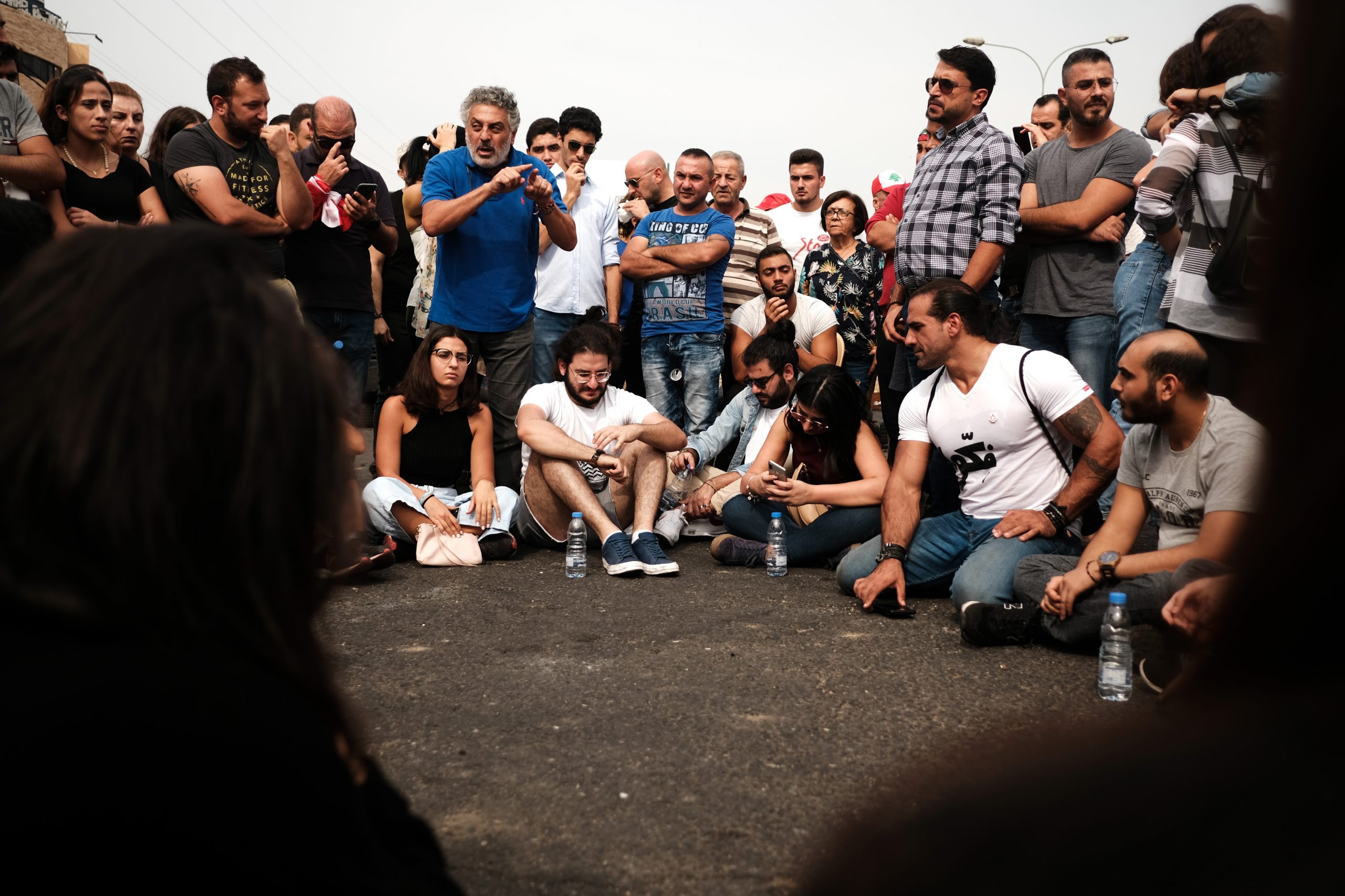 During the protests, several University professors gave their classes on the streets. On the Jbeil highway, Dr. Sharif Abdunnur, media ethics professor in LAU and AUT, gives an open class lecture and discussion on the importance of a technocratic government. (Eva Mahfouz)