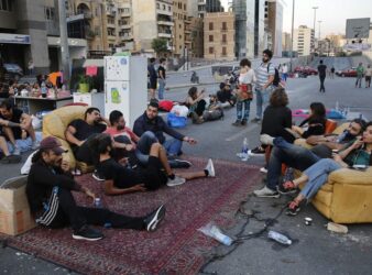 Demonstrators sit in "Beit El Cha3eb" on the Ring highway during a protest in Lebanon. (Hussein Malla/AP)