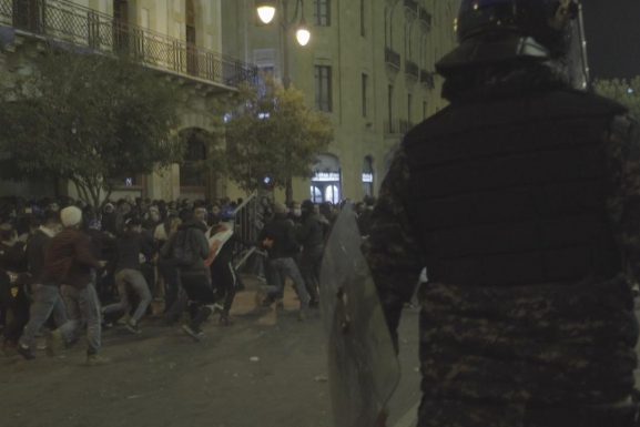 Protesters in Beirut run from Internal Security Forces on Sunday, December 15. (Lujain Jo)