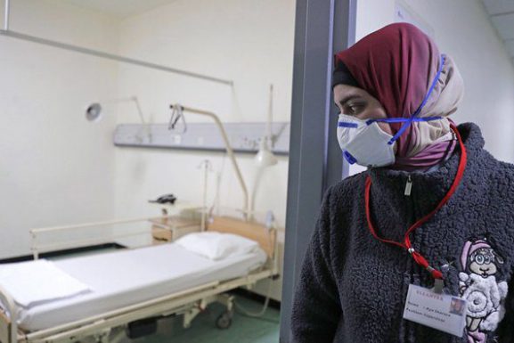 An employee wearing a protective mask near the ward where the first coronavirus case in Lebanon is being treated, at the Rafik Hariri University Hospital. (AFP / Arab News)