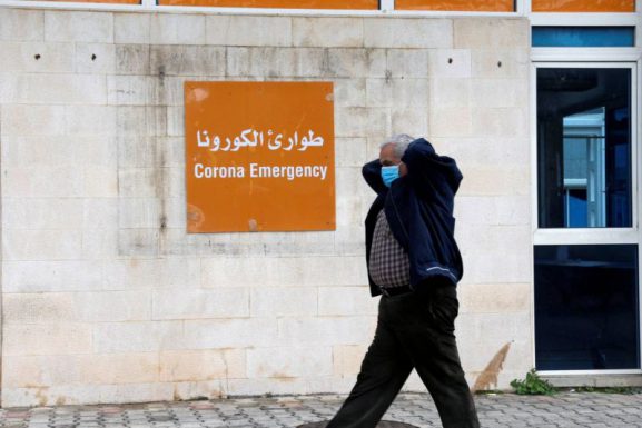 A man wears a protective mask as he walks past the coronavirus emergency department at the Rafic Hariri government hospital in Beirut, March 10, 2020. (Mohamed Azakir / Reuters / L'Orient Le Jour)
