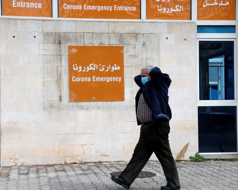 A man wears a protective mask as he walks past the coronavirus emergency department at the Rafic Hariri government hospital in Beirut, March 10, 2020. (Mohamed Azakir / Reuters / L'Orient Le Jour)