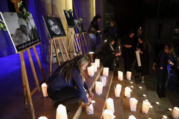 Lebanese women hold candle-lit vigil in tribute to four murdered women in Beirut, Lebanon, December 23 2017. REUTERS/Isam Abdallah
