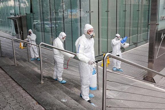 Spraying sanitising liquid around a bank in Beirut (Photo: Al-Jazeera via Anwar Amro / AFP) easing lockdown measures in Lebanon article