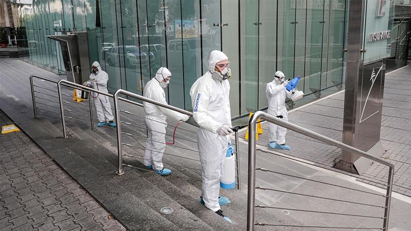 Spraying sanitising liquid around a bank in Beirut (Photo: Al-Jazeera via Anwar Amro / AFP) easing lockdown measures in Lebanon article