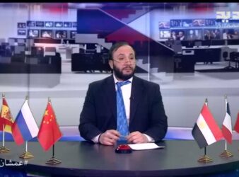 Wissam Saad sits at his desk in his persona at Al Jadeed