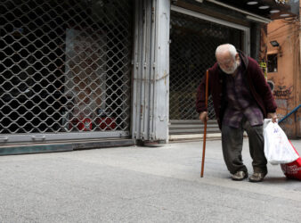 A homeless man walks past closed shops in Beirut. (PHOTO: Alhurra via REUTERS/Mohamed Azakir) | Public policy intervention article