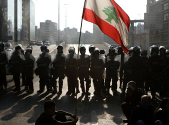 Protesters face riot police in Beirut on April 28, 2020. (PHOTO: Patrick Baz / AFP via Getty Images)