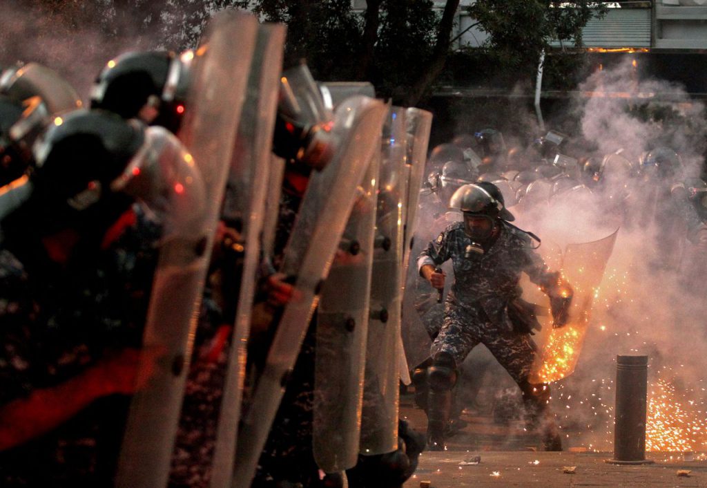 (Photo: Boston Globe via Ibrahim Amro / AFP / Getty Images) Violent security forces and protesters after Beirut blast