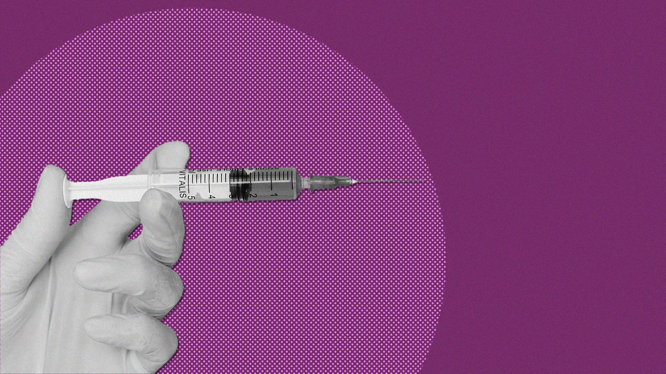 Gloved hand holding a vaccine needle with a purple backgroun