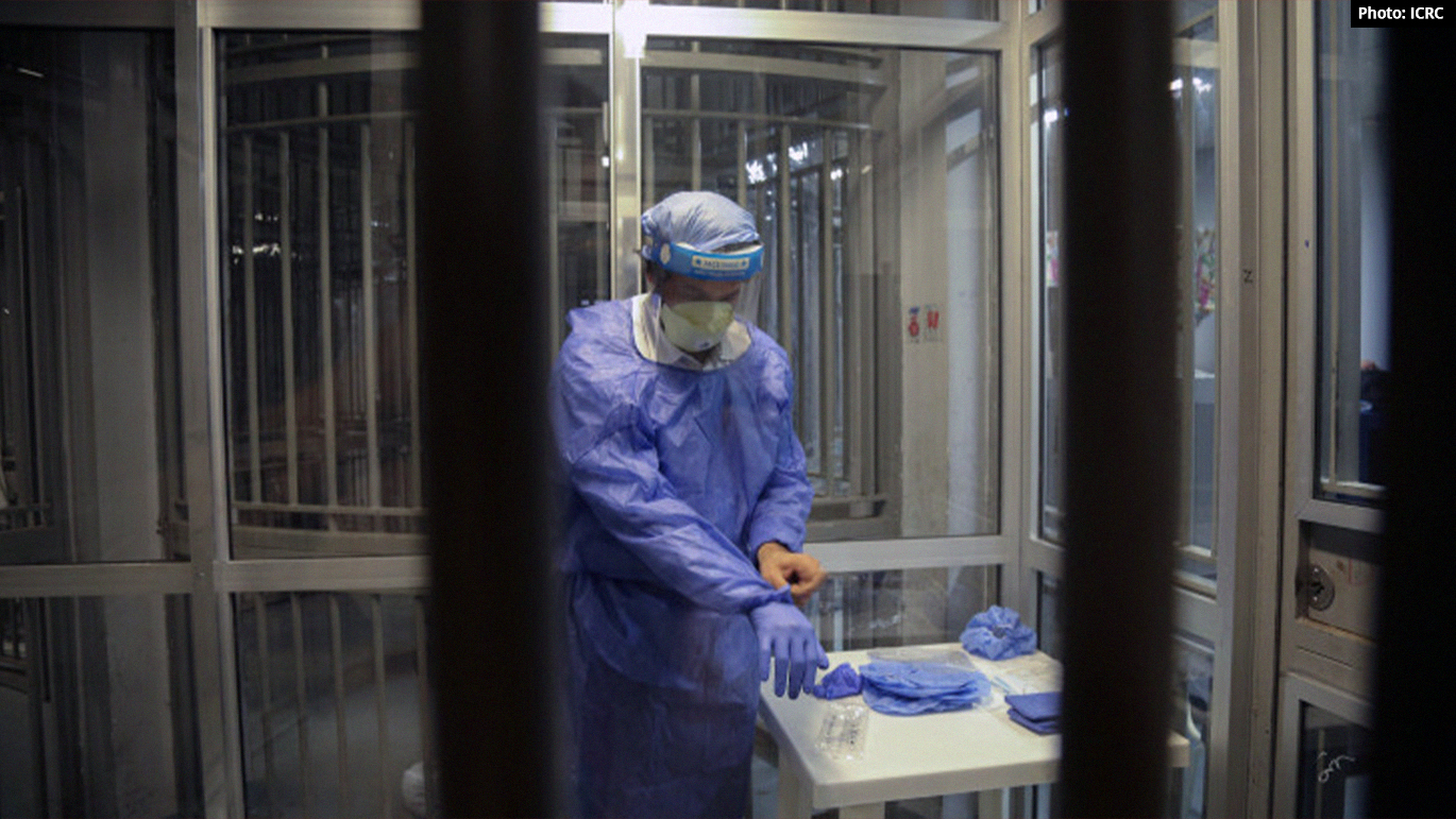 Photo: Medical staff dressed in medical gown and protective gear in a Lebanese prison. Article: WHO calls for inmate vaccination as COVID spreads in Lebanese prisons
