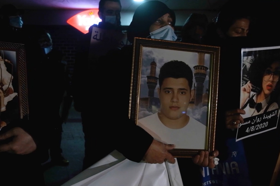Families of victims of the Beirut port explosion clutch photos of their deceased loved ones as they protest the removal of Judge Sawan from the investigation on February 18, 2021. | Photo: Ghassan Mogharbel. Rage and anger article.