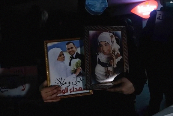 Families of the Beirut blast victims hold up photos of the loved ones they lost in the blast at a protest following the removal of Judge Fadi Sawan from the case. (Photo: Ghassan Mogharbel)