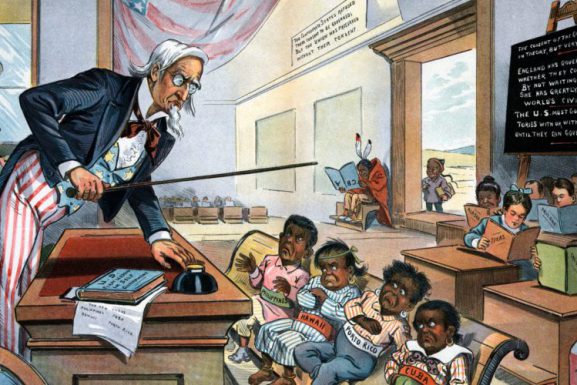 In this 1899 cartoon published, Uncle Sam lectures his new students: The Philippines, Hawaii, Puerto Rico, and, Cuba. Past and potentially future U.S. acquisitions fill the rest of the classroom.