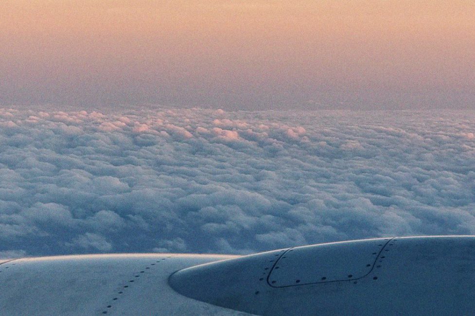 Photographer from window of a plane showing wing of plane and background full of clouds. For article: “I could not see a future”: Lebanon losing youth in new wave of emigration