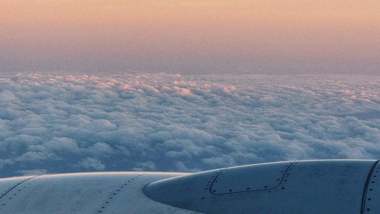 Photographer from window of a plane showing wing of plane and background full of clouds. For article: “I could not see a future”: Lebanon losing youth in new wave of emigration