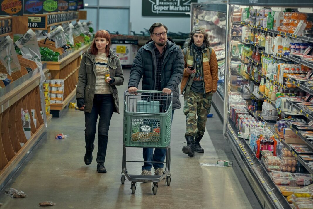 Still from Don't Look Up where Leonardo DiCaprio, Jennifer Lawrence, and Timothée Chalamet are walking in a dishevelled supermarket.
