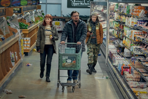 Still from Don't Look Up where Leonardo DiCaprio, Jennifer Lawrence, and Timothée Chalamet are walking in a dishevelled supermarket.